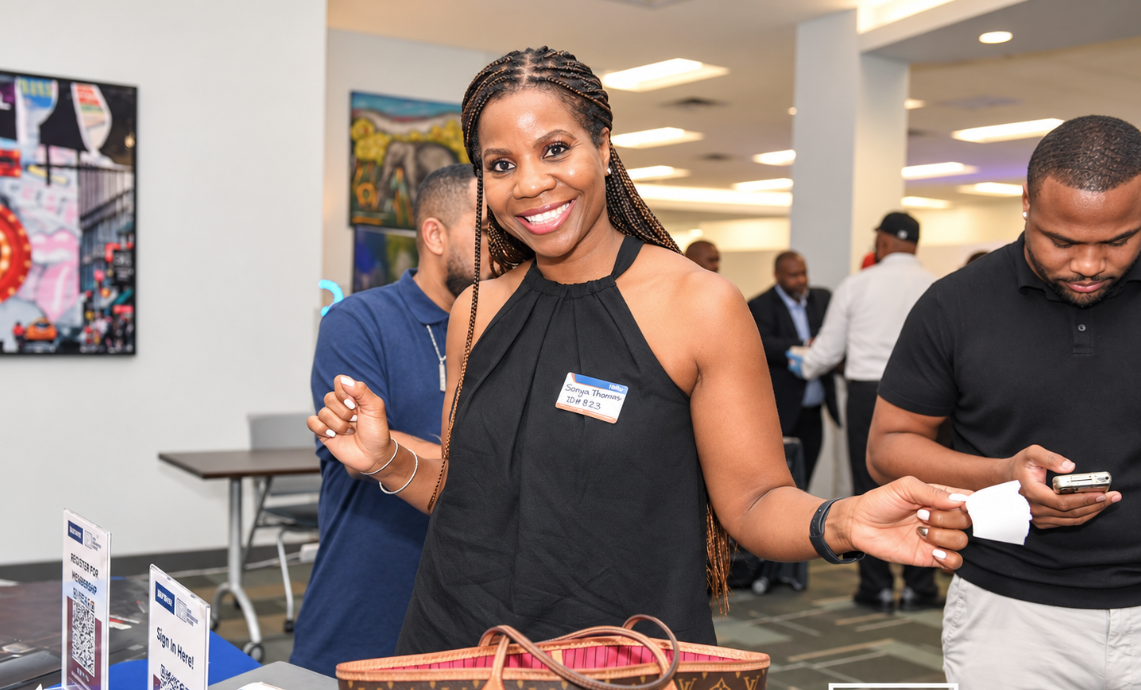 A guest checking in at the registration table during a HUB event
